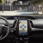 A car dashboard with the steering wheel and dashboard camera.