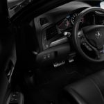 A car 's dashboard and steering wheel in black.