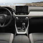 A dashboard and steering wheel of a car.
