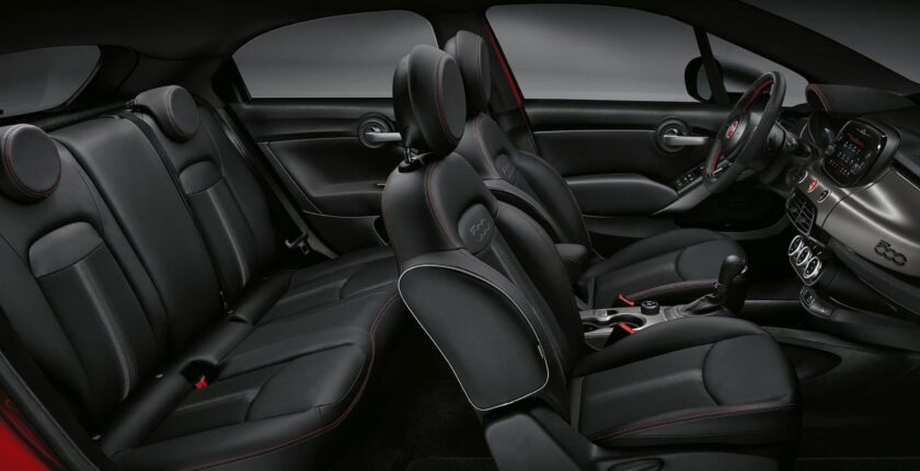 A car with black leather seats and the back seat folded down.