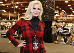 A woman in red and black plaid jacket posing for the camera.