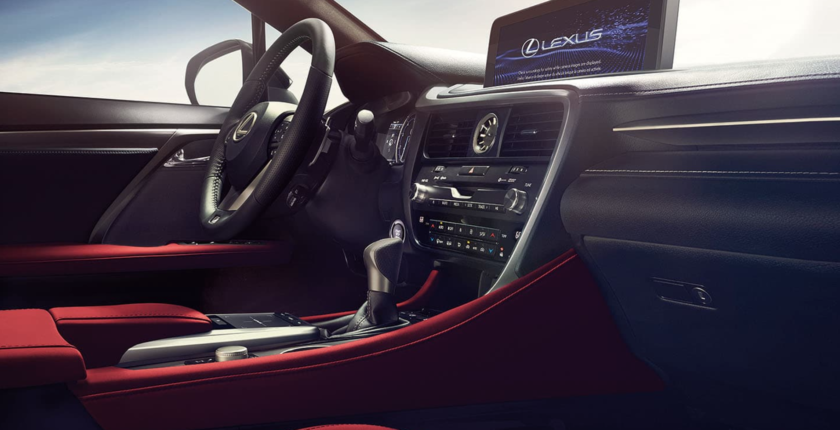 A car dashboard with the steering wheel and infotainment system.