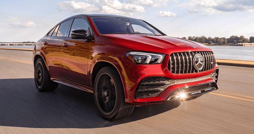 A red mercedes benz gle coupe driving down the road.