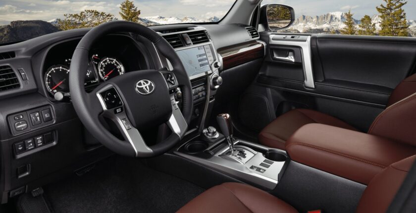 A dashboard and steering wheel of a toyota 4 runner.