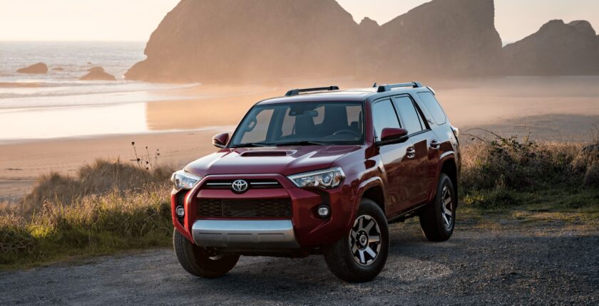 A red toyota 4 runner parked on top of a hill.