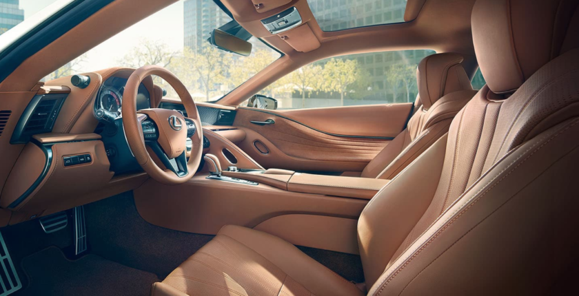 A car with tan leather interior and steering wheel.