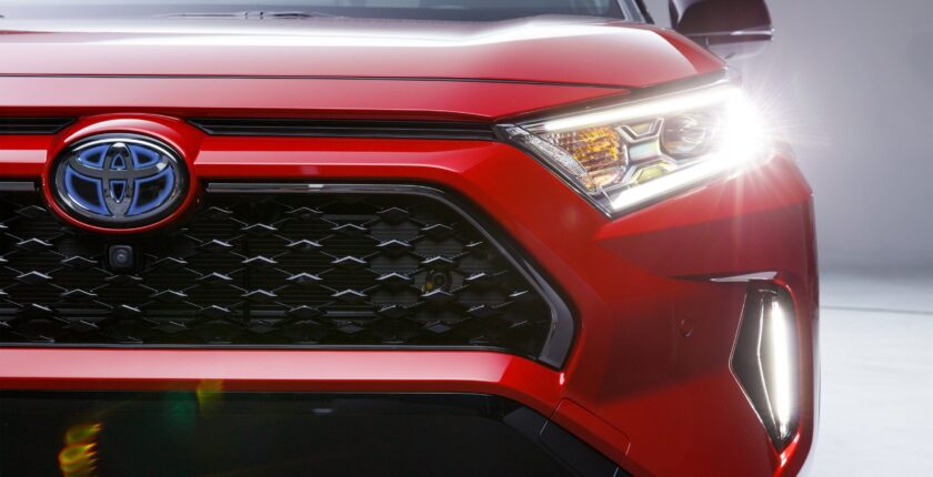 A close up of the front grill on a red car