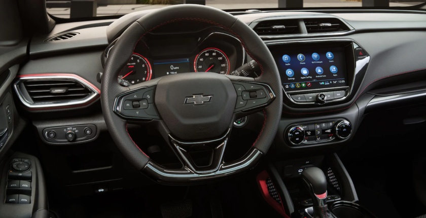 A steering wheel and dashboard of a car.