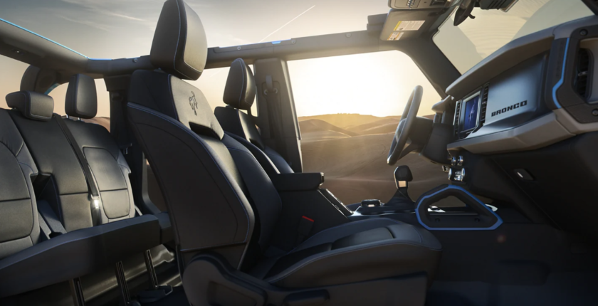 A view of the inside of a vehicle with the sun setting.