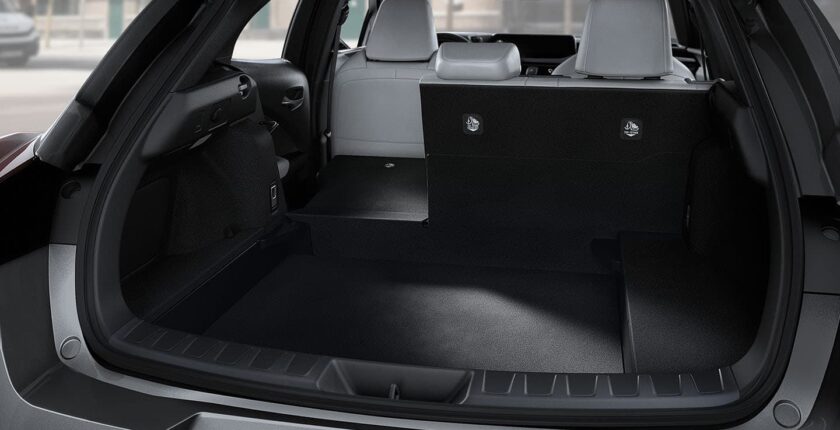 A trunk of a car with the seats folded down.