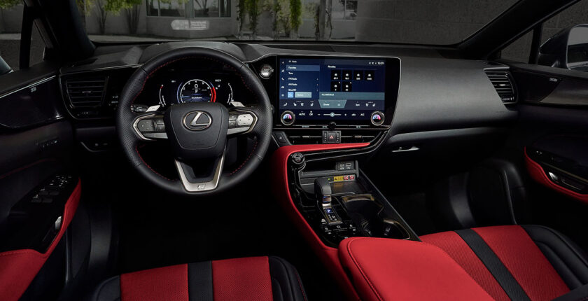 A red and black car interior with the dashboard.