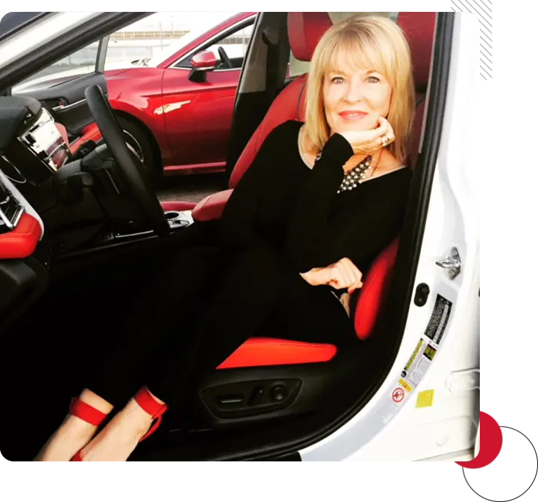 A woman sitting in the passenger seat of a car.